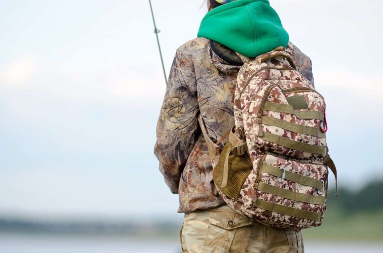 Man wearing brown tactical backpack photographed from behind Man wearing brown tactical backpack photographed from behind