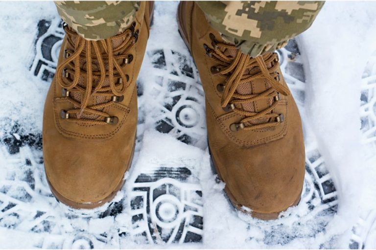 Pair of tactical boots in snow Pair of tactical boots in snow