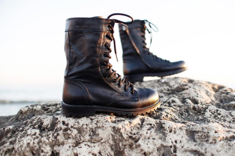 Pair of tactical boots on rocks Pair of tactical boots on rocks
