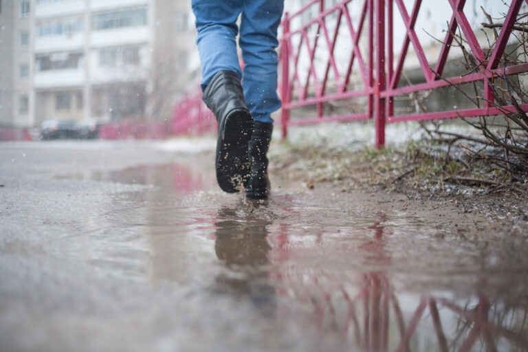 Man wearing tactical boots running in wet conditions